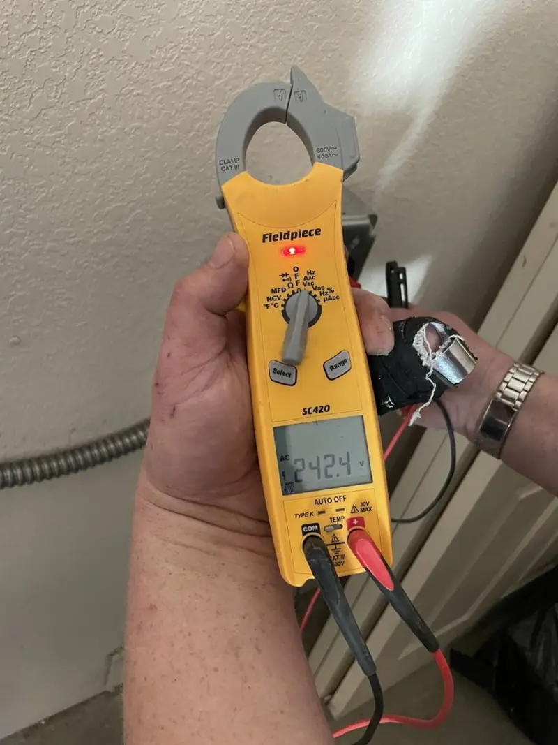 Voltage testing with clamp meter during Whole House Surge Protector in West Manheim